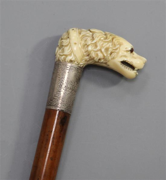 A good mid 19th century carved ivory handled cane, length 35.25in.